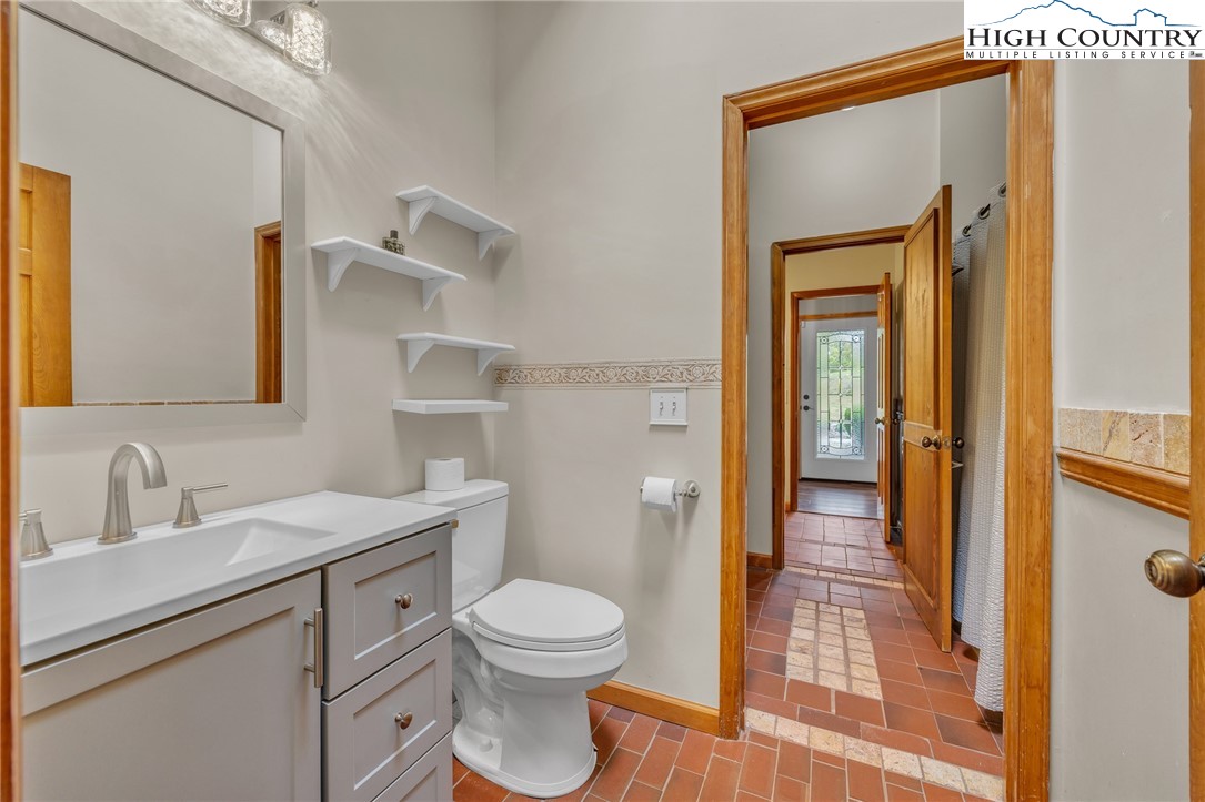 255 Clear View Ridge Crumpler, NC 28617 - Photo 17 of 42 a bathroom with a toilet a sink and a mirror