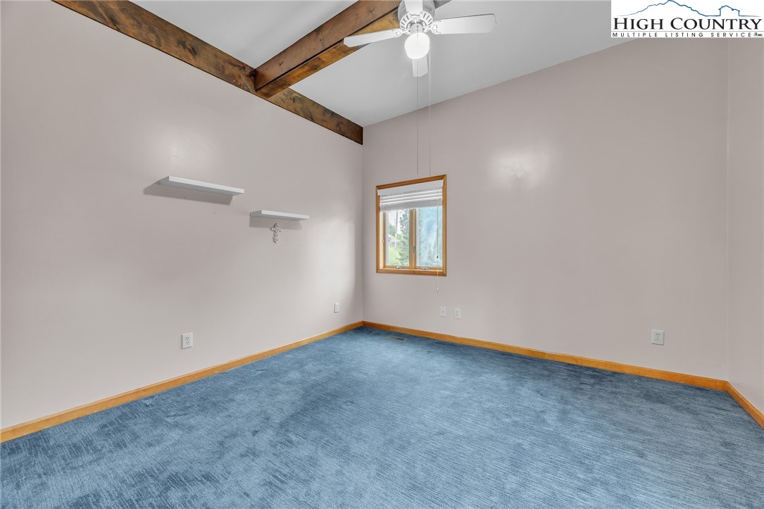 255 Clear View Ridge Crumpler, NC 28617 - Photo 26 of 42 an empty room with a ceiling fan and windows