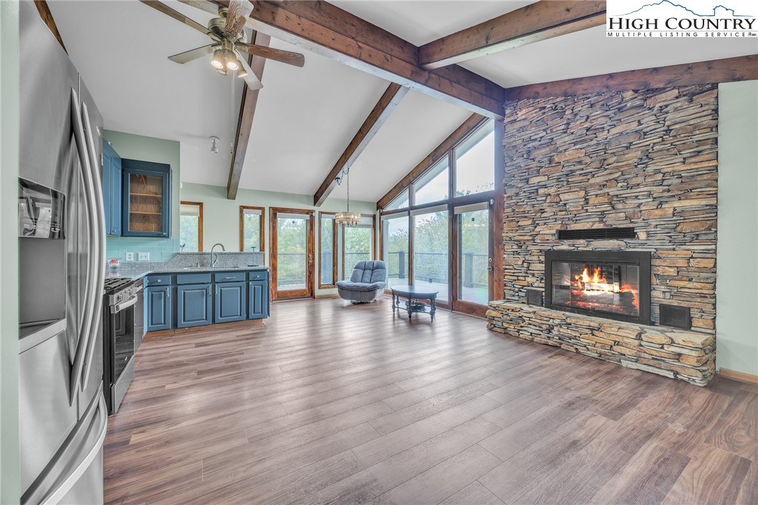 255 Clear View Ridge Crumpler, NC 28617 - Photo 6 of 42 a view of a livingroom with wooden floor and a fireplace
