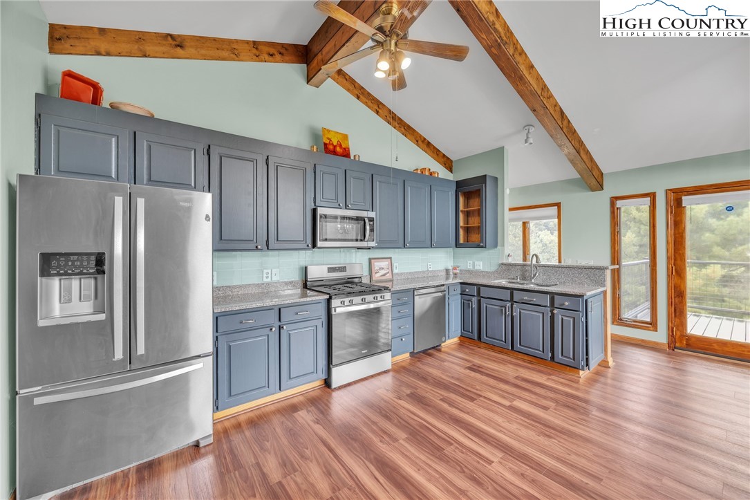 255 Clear View Ridge Crumpler, NC 28617 - Photo 10 of 42 a kitchen with granite countertop stainless steel appliances and wooden cabinets