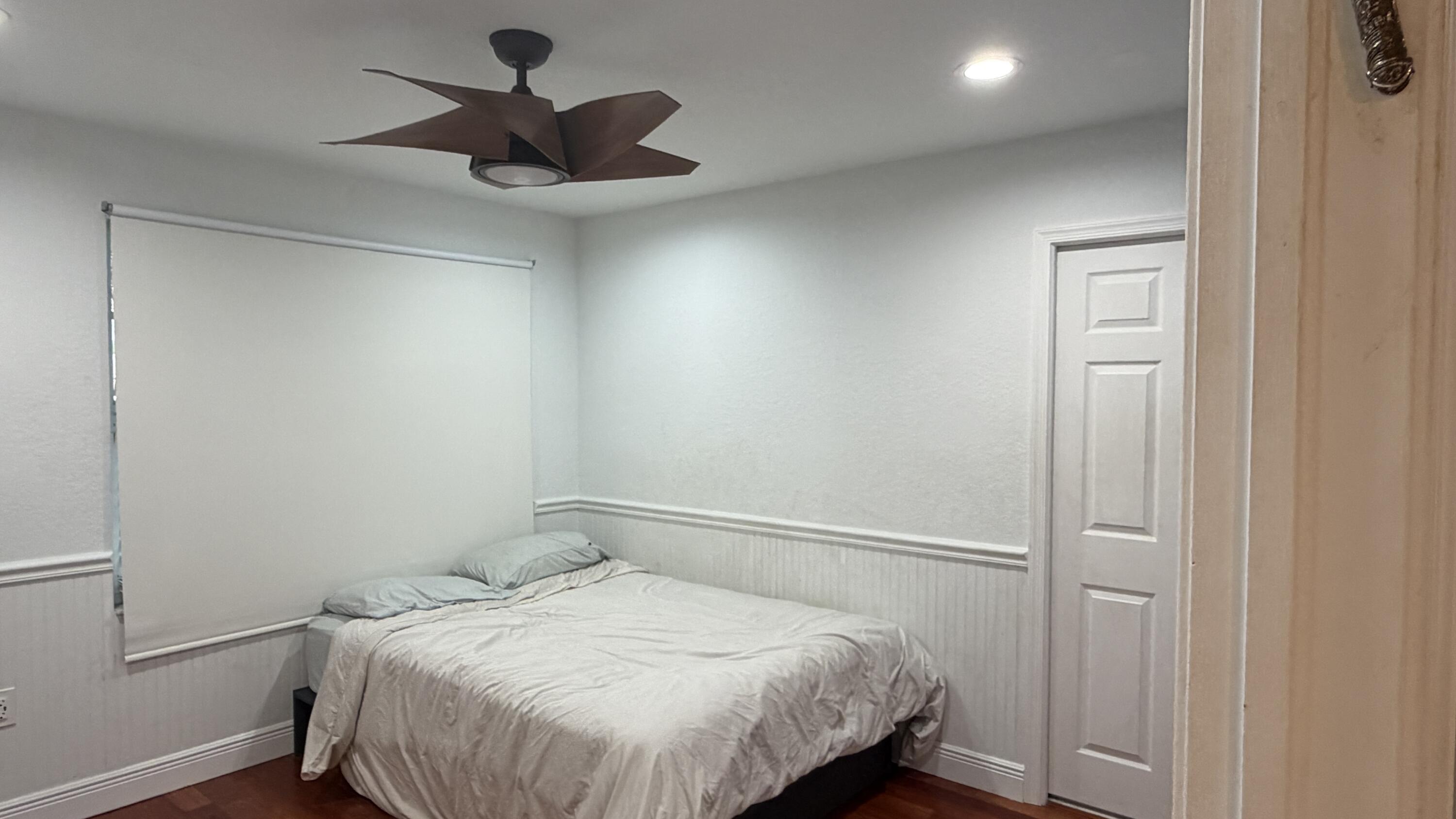 19125 Skyridge Circle Boca Raton, FL 33498 - Photo 15 of 28 a bedroom with a bed and a chandelier