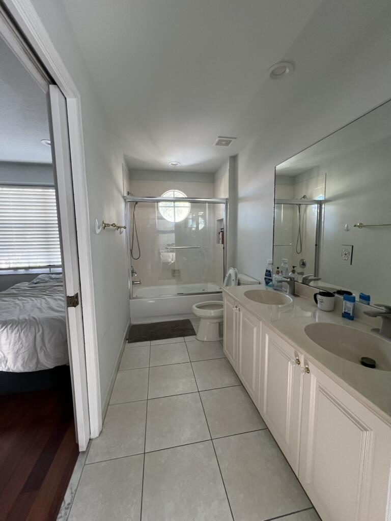 19125 Skyridge Circle Boca Raton, FL 33498 - Photo 18 of 28 a large white kitchen with a sink a refrigerator and window
