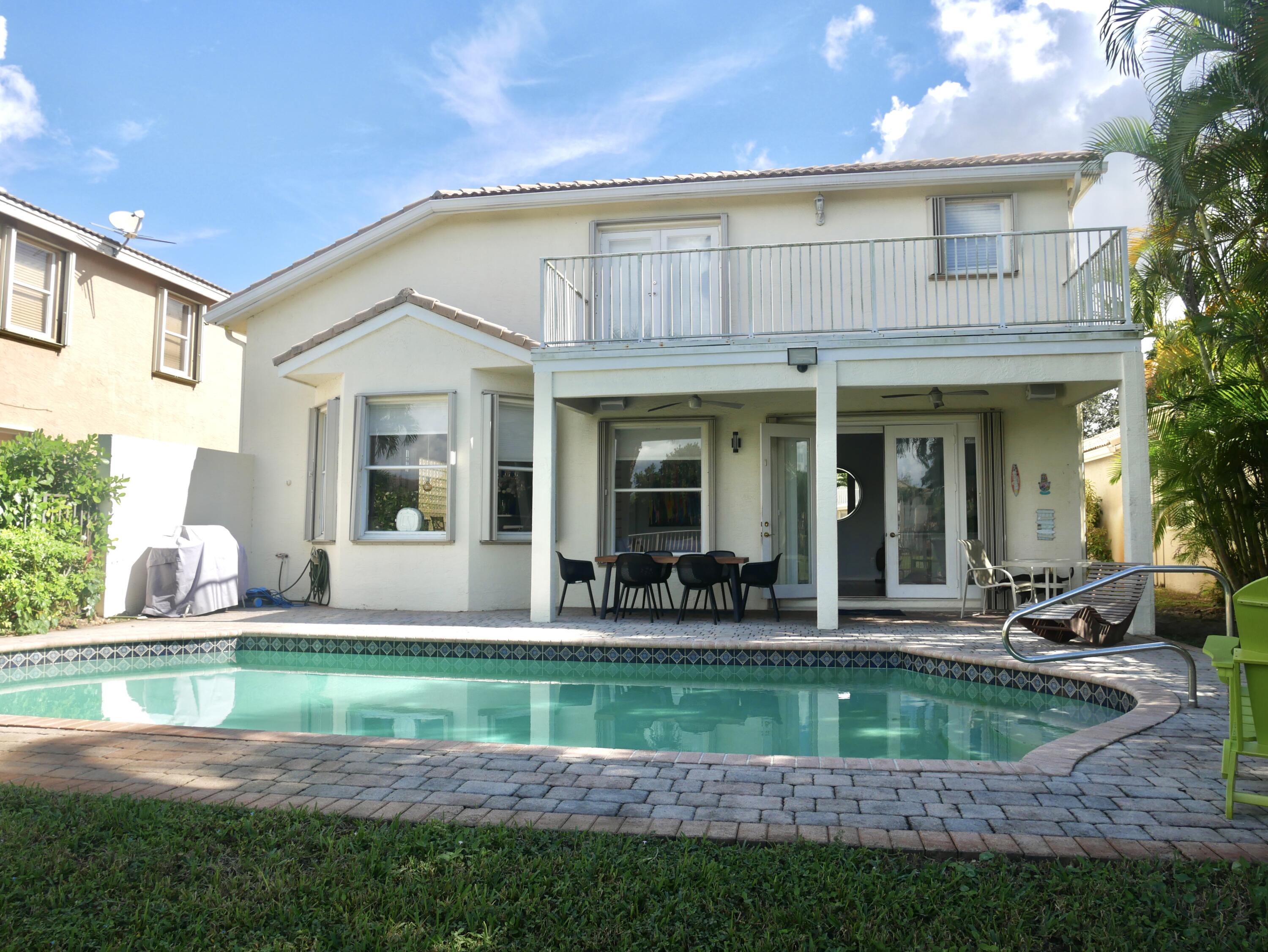 19125 Skyridge Circle Boca Raton, FL 33498 - Photo 27 of 28 a front view of a house with a yard table and chairs