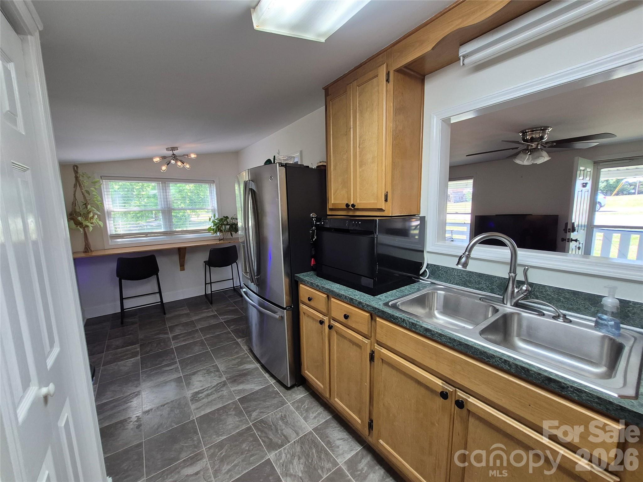 4438 Reepsville Road Vale, NC 28168 - Photo 20 of 32 a kitchen with stainless steel appliances a sink cabinets and a window