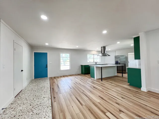 a view of kitchen with kitchen island sink refrigerator and stove
