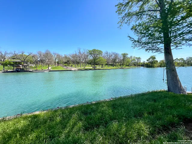 a view of a lake with houses in the back