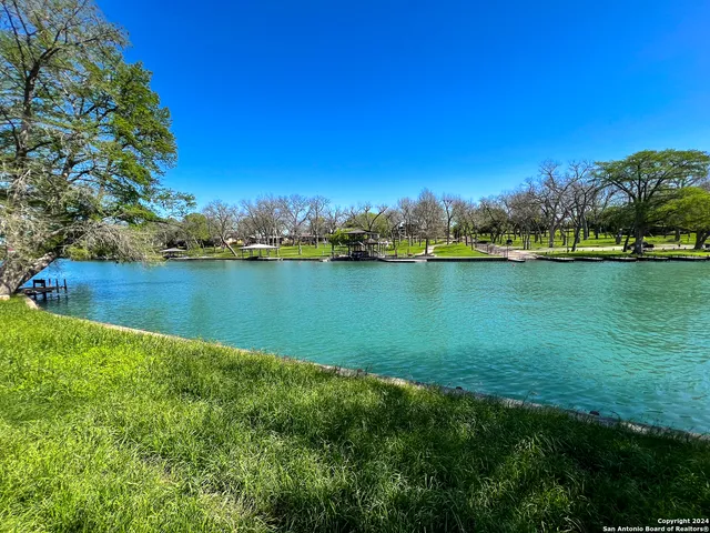 a view of a lake with houses in the back