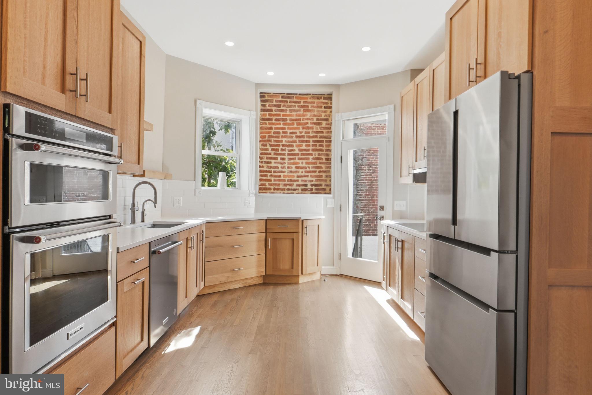 706 12th Street Northeast Washington, DC 20002 - Photo 9 of 49 a kitchen with stainless steel appliances a refrigerator sink and microwave