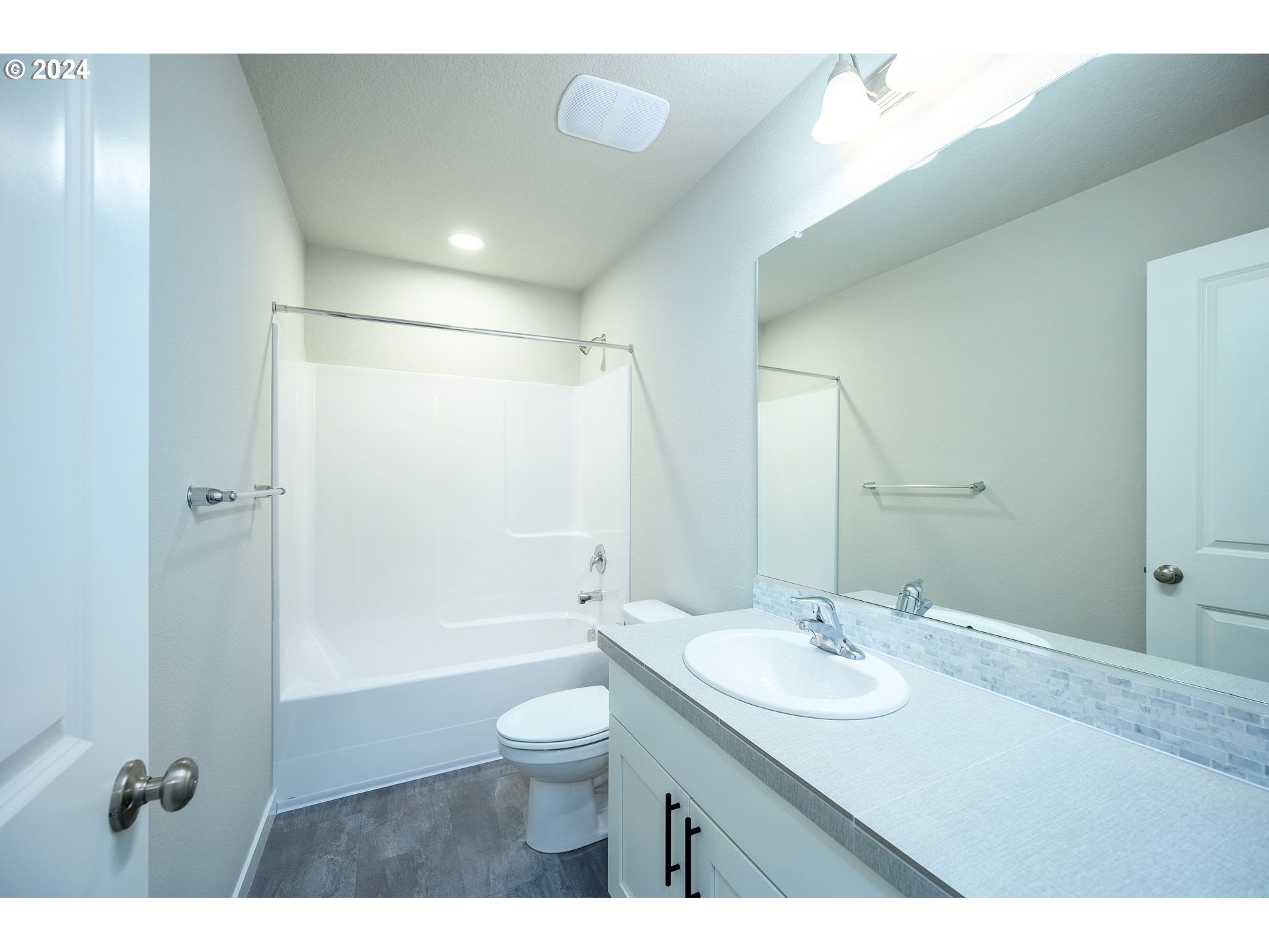 123 North 88th Drive, Unit 53 Ridgefield, WA 98642 - Photo 44 of 46 a bathroom with a shower sink vanity mirror and toilet