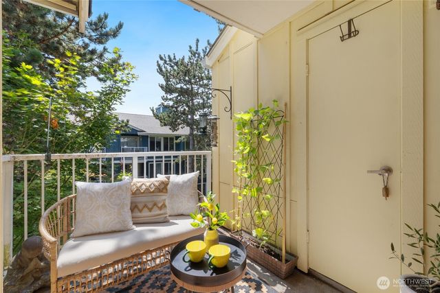 a balcony with furniture and potted plant