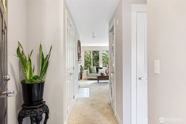 a hallway with a dining table and a potted plant