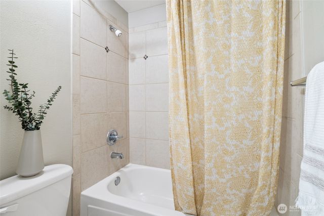 a bathroom with a shower curtain and a sink