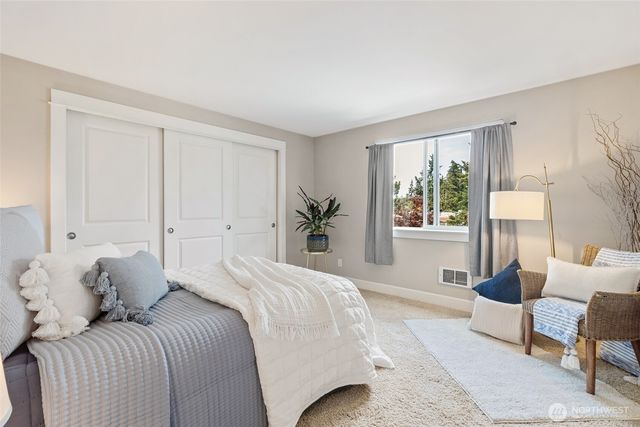 a bedroom with a large bed and a window