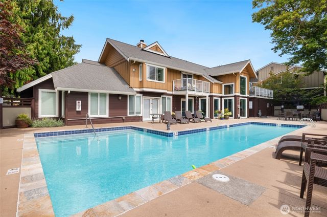 a view of a house with swimming pool and porch
