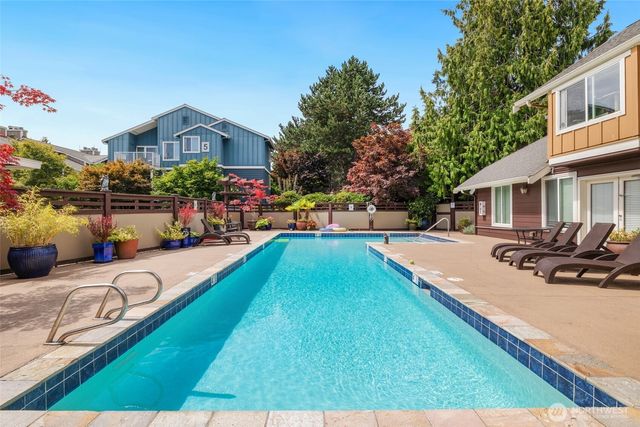 a view of a house with swimming pool and sitting area