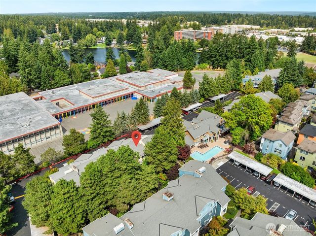an aerial view of residential houses with outdoor space and river