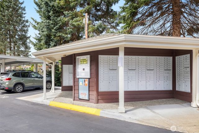 a view of a house with large windows and a car park front of house