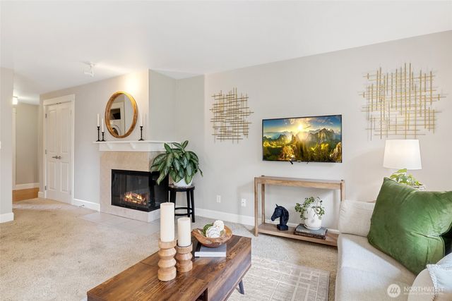 a living room with furniture fireplace and flat screen tv