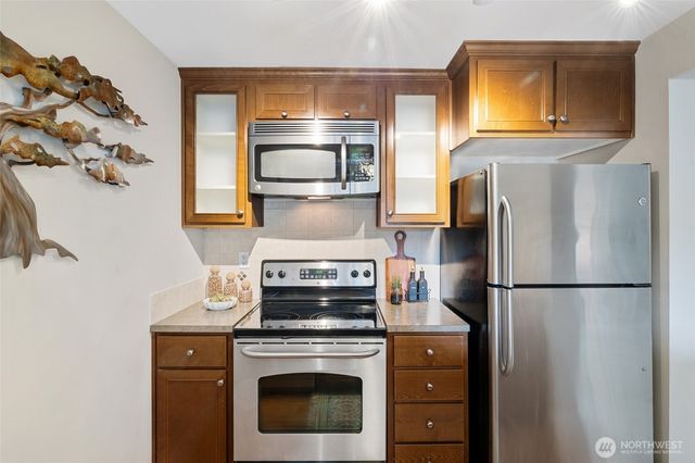 a kitchen with a refrigerator stove and microwave