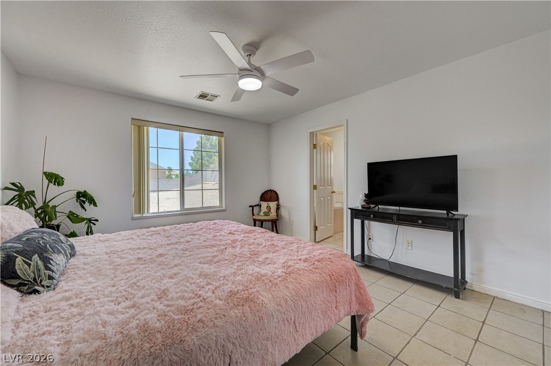 1272 Liston Avenue Logandale, NV 89021 - Photo 33 of 61 A well-lit sleeping area offers generous space, tiled flooring, and a large window providing ample natural light.