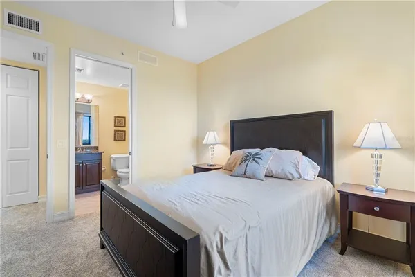 a bedroom with a bed and a lamp on table