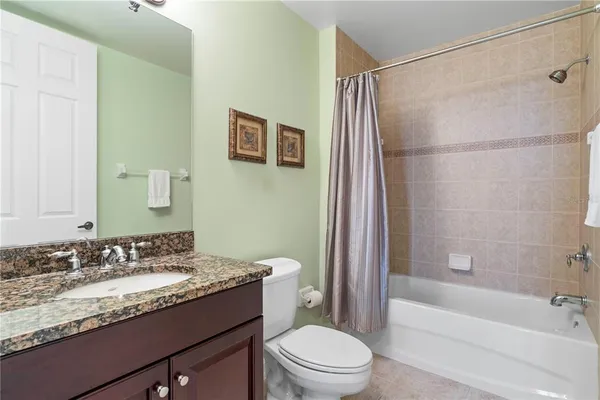 a spacious bathroom with a bathtub sink and mirror