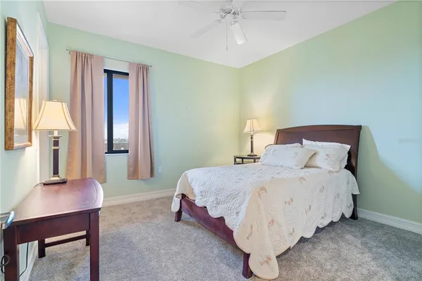 a bathroom with a granite countertop double vanity sink and a mirror