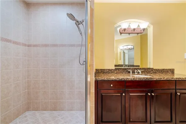 a view of white house with a yard and potted plants