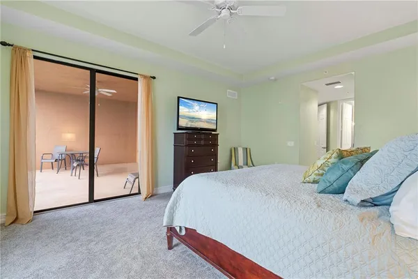 a view of a patio with couches table and chairs and potted plants