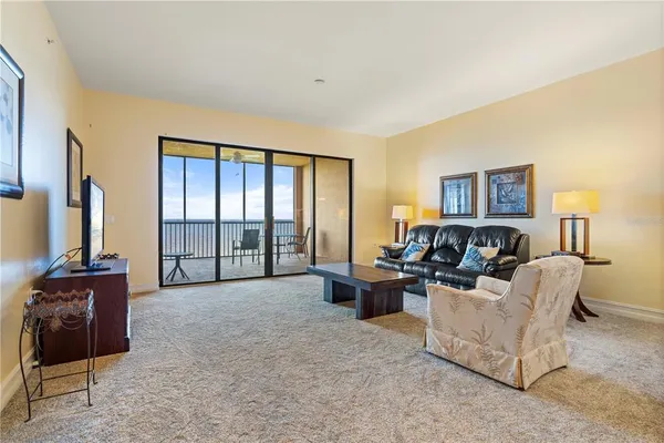 a front view of a house with swimming pool patio and lake view