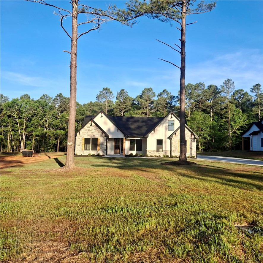 4554 Flat Rock Road Iva, SC 29655 - Photo 1 of 32 A new construction home with stone and board and batten siding, nestled among mature trees.