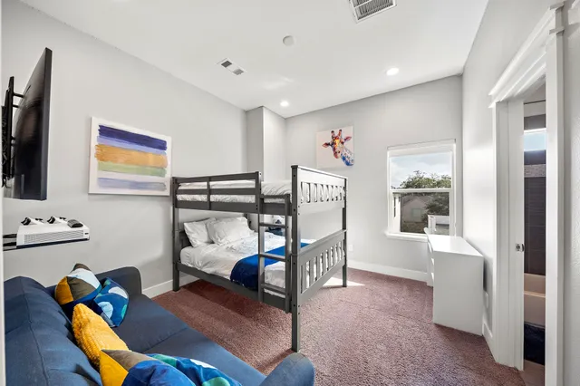 a bedroom with furniture and a window