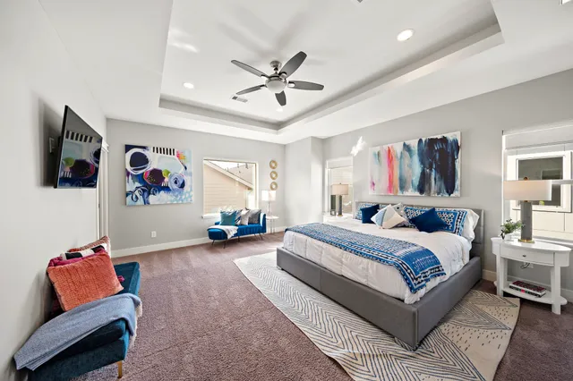 a spacious bedroom with a bed and furniture