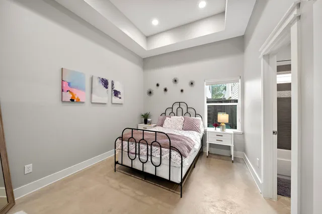 a bedroom with a bed and a painting on the wall