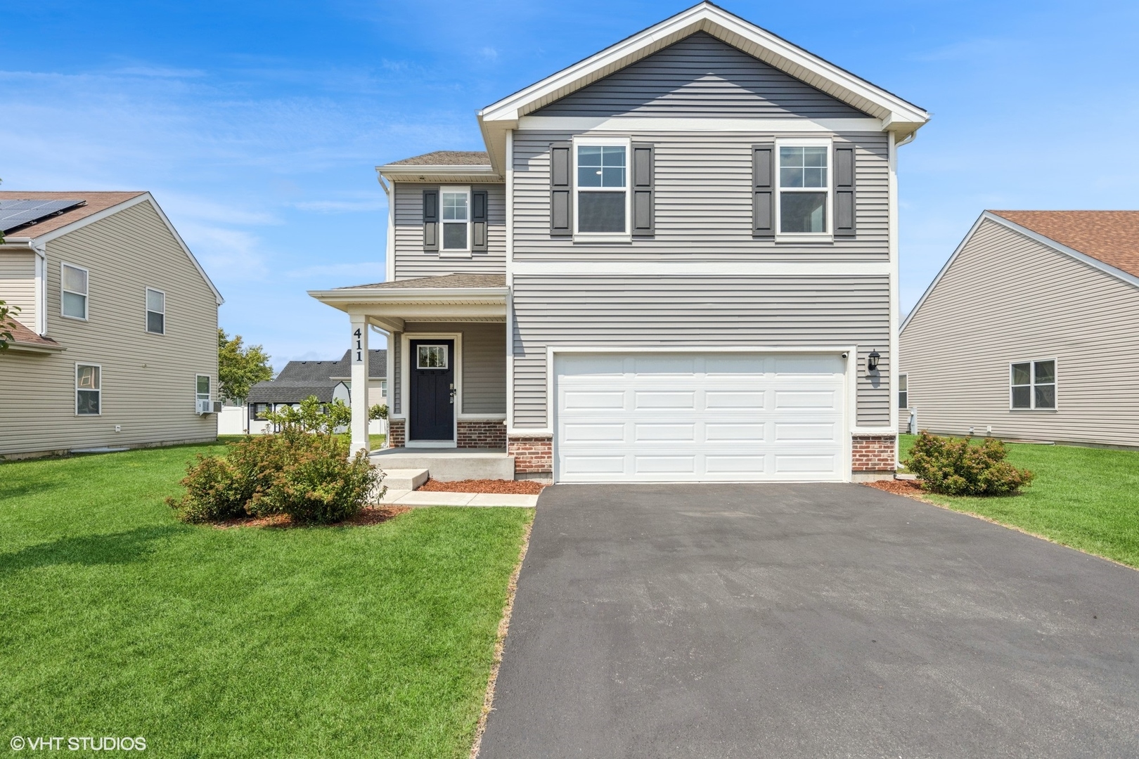 411 Stockton Drive Joliet, IL 60421 - Photo 1 of 29 a front view of a house with a yard and garage