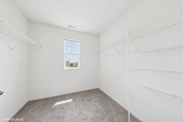 a view of a small space with wooden floor and a window