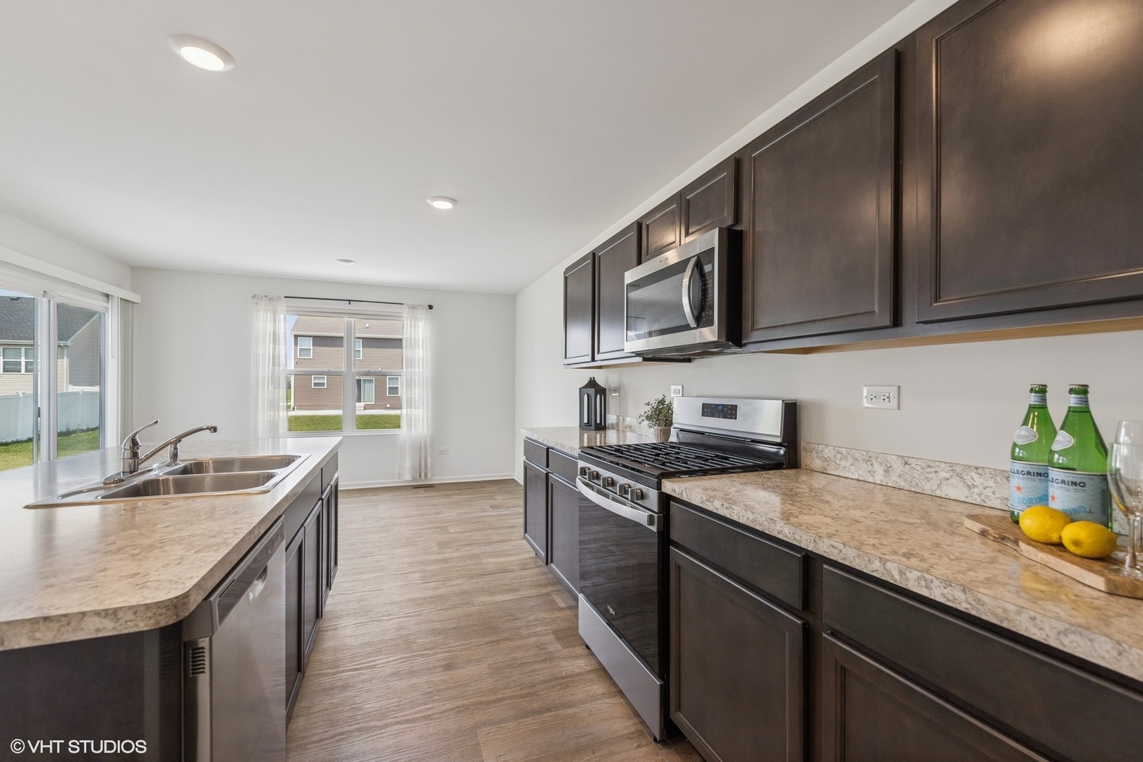 411 Stockton Drive Joliet, IL 60421 - Photo 5 of 29 a kitchen with stainless steel appliances granite countertop a sink stove and refrigerator