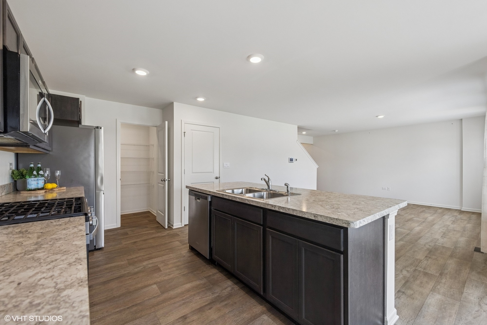 411 Stockton Drive Joliet, IL 60421 - Photo 6 of 29 a kitchen with a sink refrigerator and cabinets