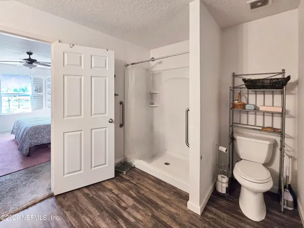 a large bathroom with a sink a mirror and a shower