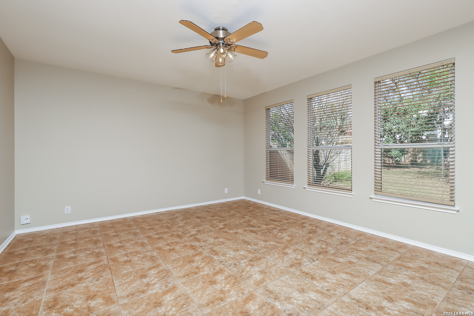 8611 Tioga Pass Helotes, TX 78023 - Photo 7 of 14 a view of a big room with windows and chandelier fan