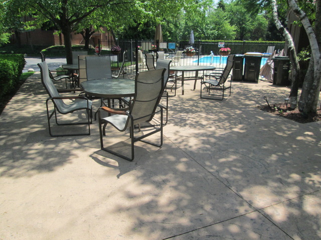 75 Boardwalk Place, Unit 101 Park Ridge, IL 60068 - Photo 15 of 16 a view of a backyard with table and chairs