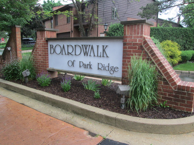 75 Boardwalk Place, Unit 101 Park Ridge, IL 60068 - Photo 2 of 16 a sign on the side of a building