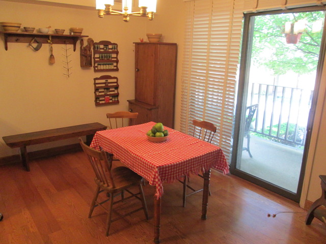 75 Boardwalk Place, Unit 101 Park Ridge, IL 60068 - Photo 7 of 16 a dining room with furniture and wooden floor