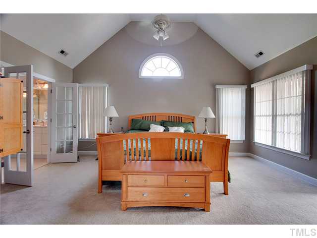 4617 Mentone Way Raleigh, NC 27612 - Photo 13 of 23 a bedroom with a bed window and a night stand in it