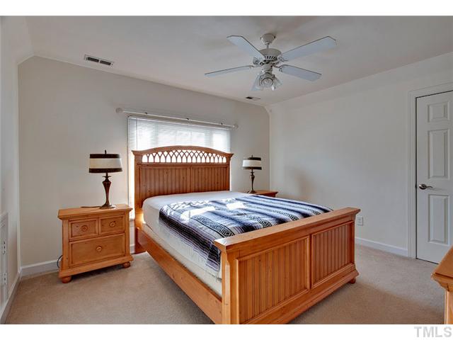 4617 Mentone Way Raleigh, NC 27612 - Photo 16 of 23 a bedroom with a bed and a chandelier