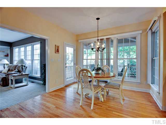 4617 Mentone Way Raleigh, NC 27612 - Photo 9 of 23 a dining room with furniture wooden floor a chandelier