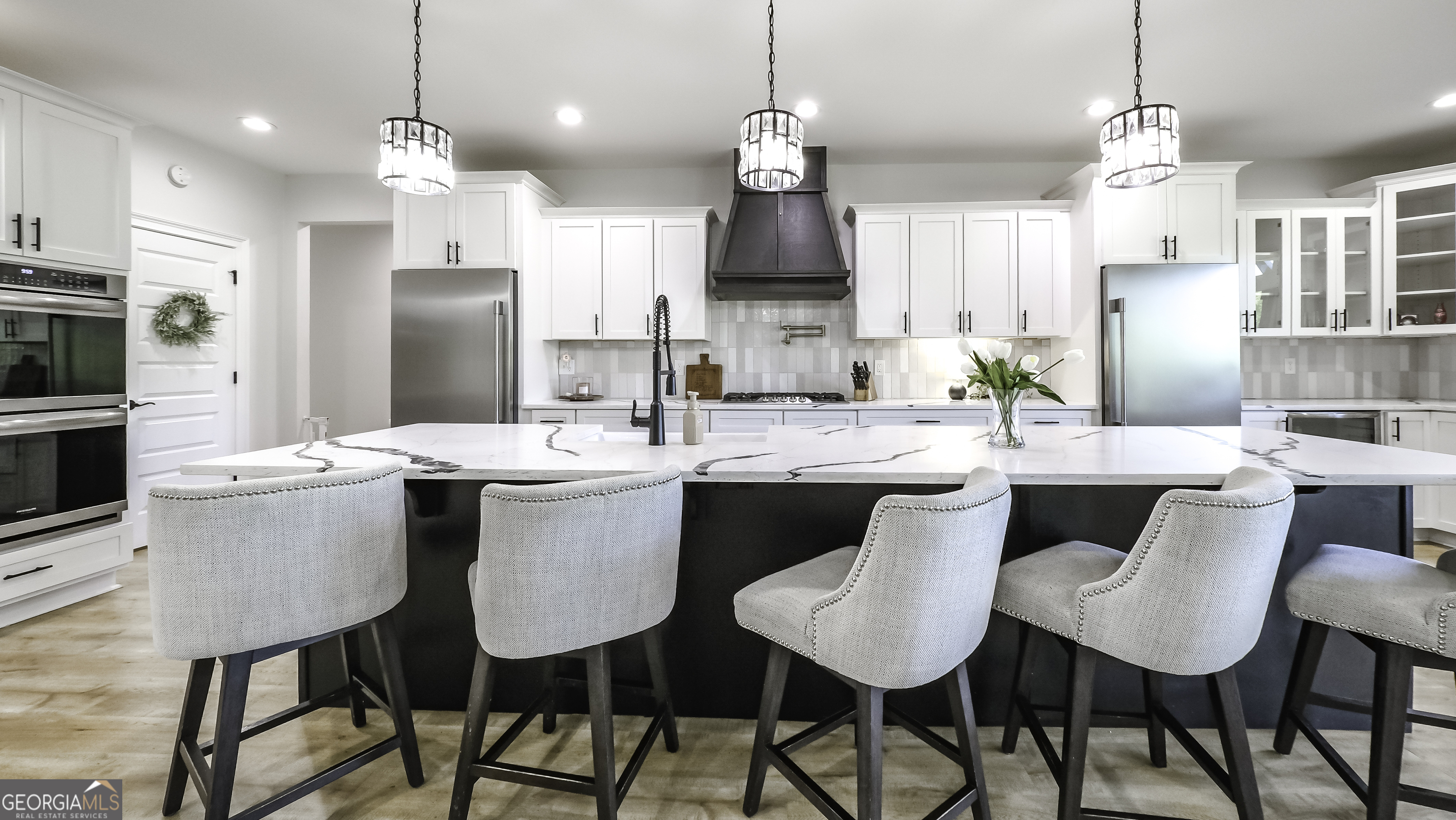 2392 Welcome Road Roopville, GA 30170 - Photo 12 of 43 a kitchen with a dining table chairs refrigerator and microwave