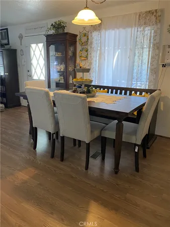 a view of a a dining room with furniture window and wooden floor
