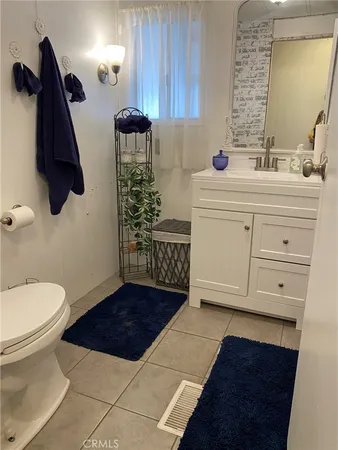 a bathroom with a sink a toilet and mirror