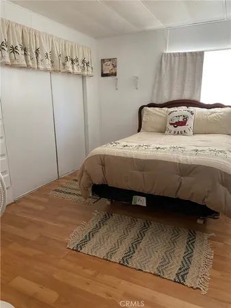 a bedroom with a bed and a night stand